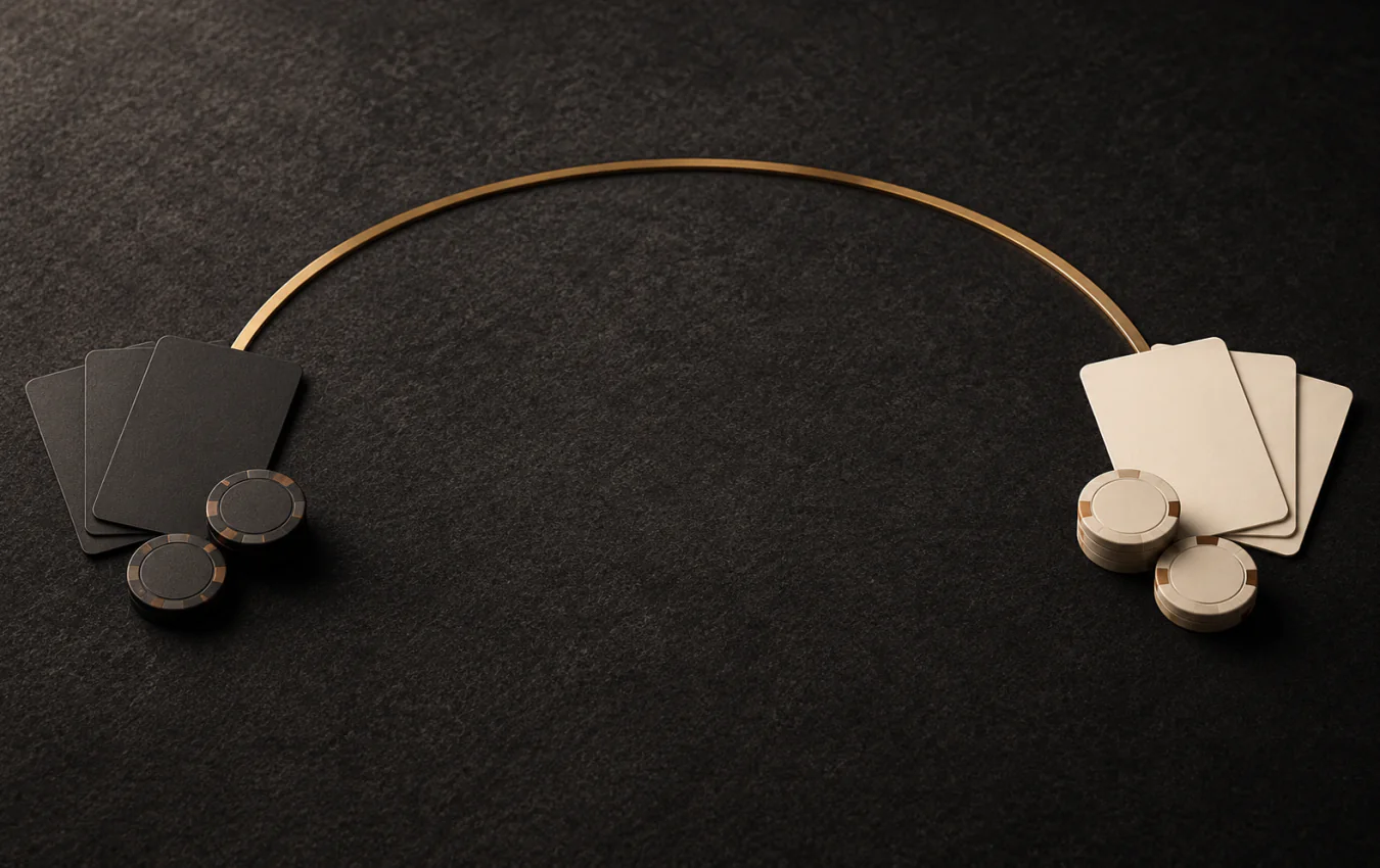 Dark and light groups of blank playing cards and unmarked chips separated by an empty middle beneath a brass arc